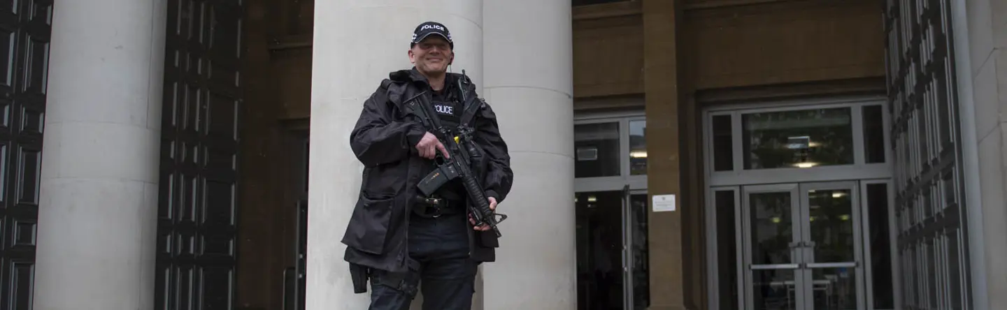 Ministry of Defence Police Officer holding a firearm in front of the Ministry of Defence Main Building in Whitehall, London
