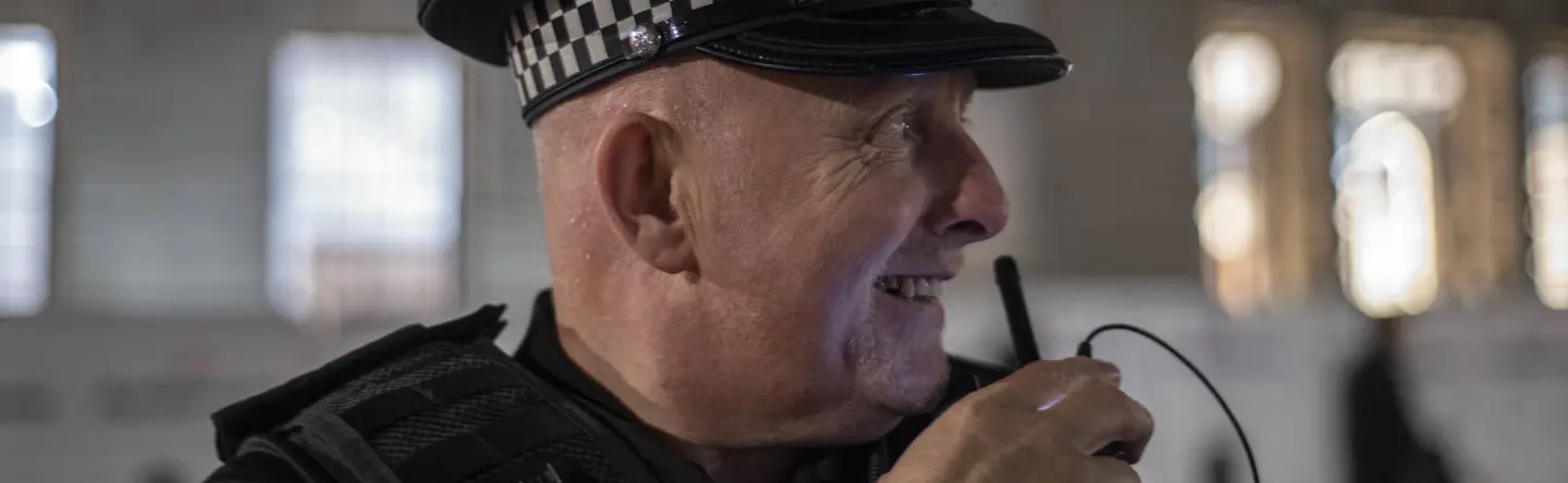 Ministry of Defence Police officer using his radio