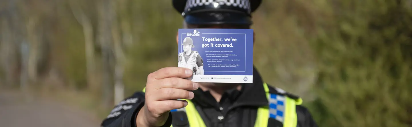 Ministry of Defence Police Project Servator officer holding a handbill