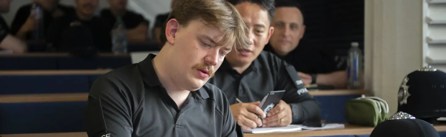 Two Ministry of Defence Police students in a classroom