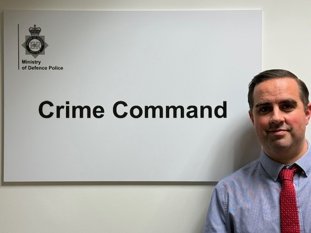 DS French in front of Crime Command sign