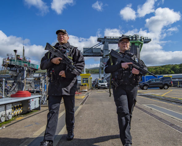 MDP PC Authorised Firearms Officers on patrol, on road at Naval Base