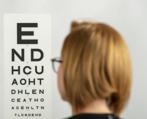 Person looking at chart on wall during eye test