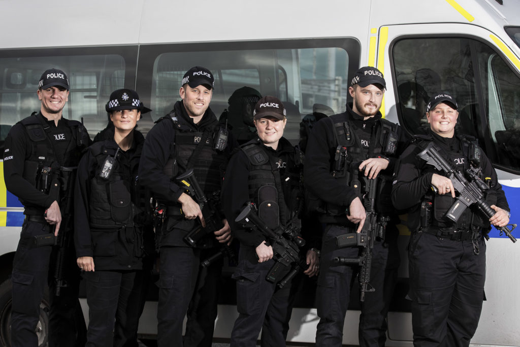MDP Authorised Firearms Officers standing beside a police van